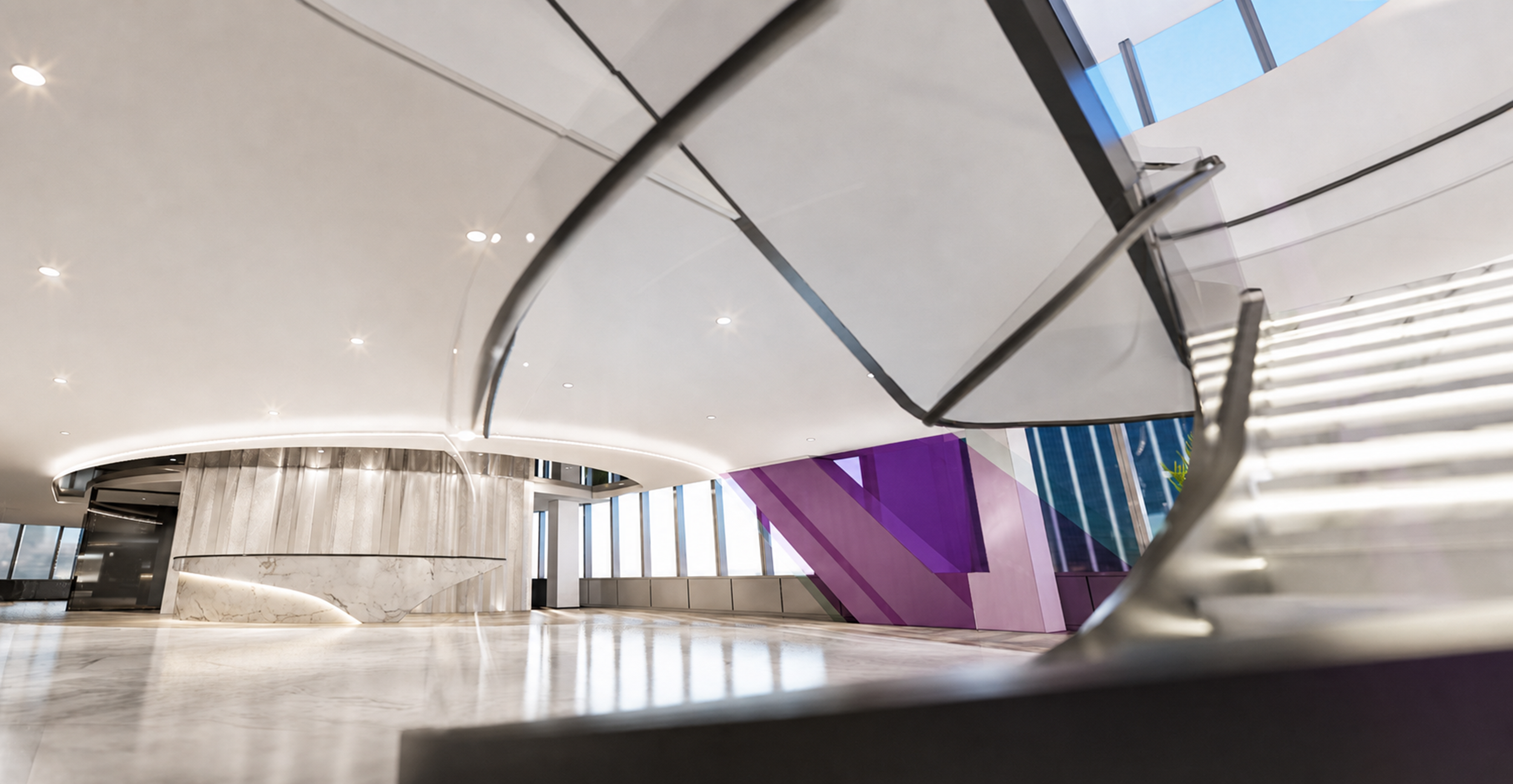 Reception with flowing ceiling forms and a purple feature stair